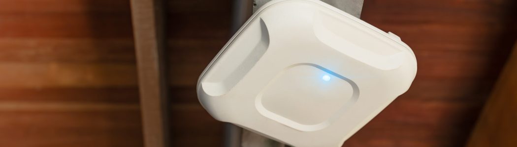 Wireless router for internet local network at ceiling. Indoor networking technology. WIFI router Wireless router for internet local network at ceiling. Indoor networking technology. WIFI router or Wireless Access Point setup at ceiling for Internet connection office space or cafe.